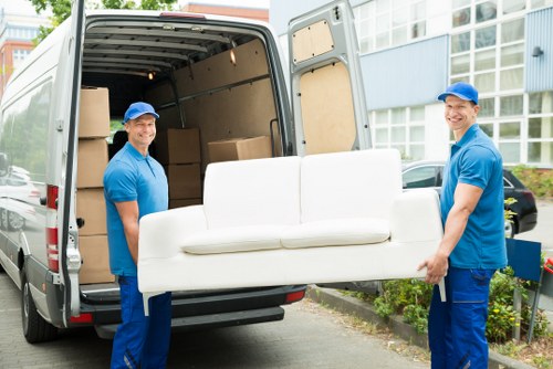 Van parked on Marylebone street with workers loading furniture
