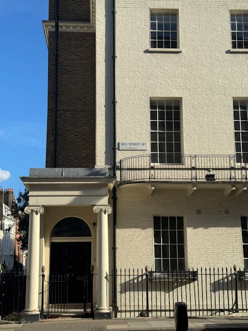 A close-up view of a traditional pub or shop sign mounted on the exterior of a narrow, brick-fronted building on Marylebone High Street, displaying the name 'The Marylebone' along with the address 'No
